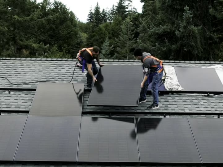 Meyer Electric crew setting solar panels on a Peninsula roof